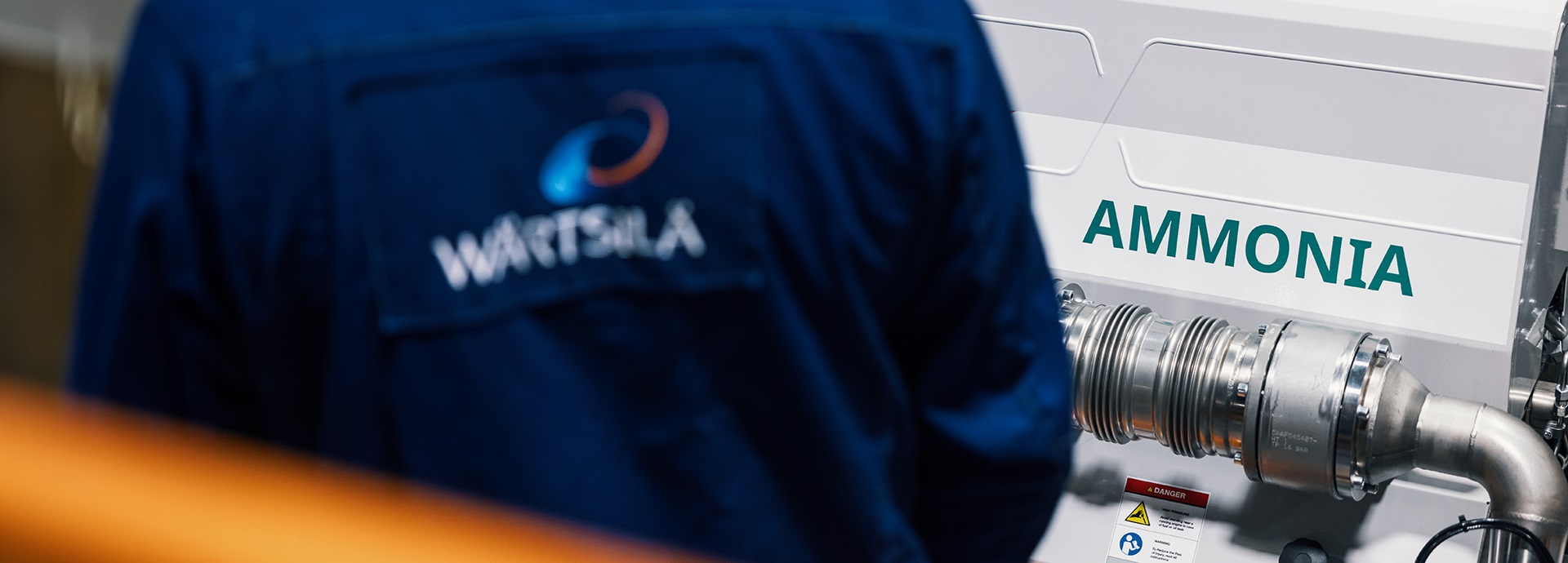 Wärtsilä employee in front of an engine running with Ammonia