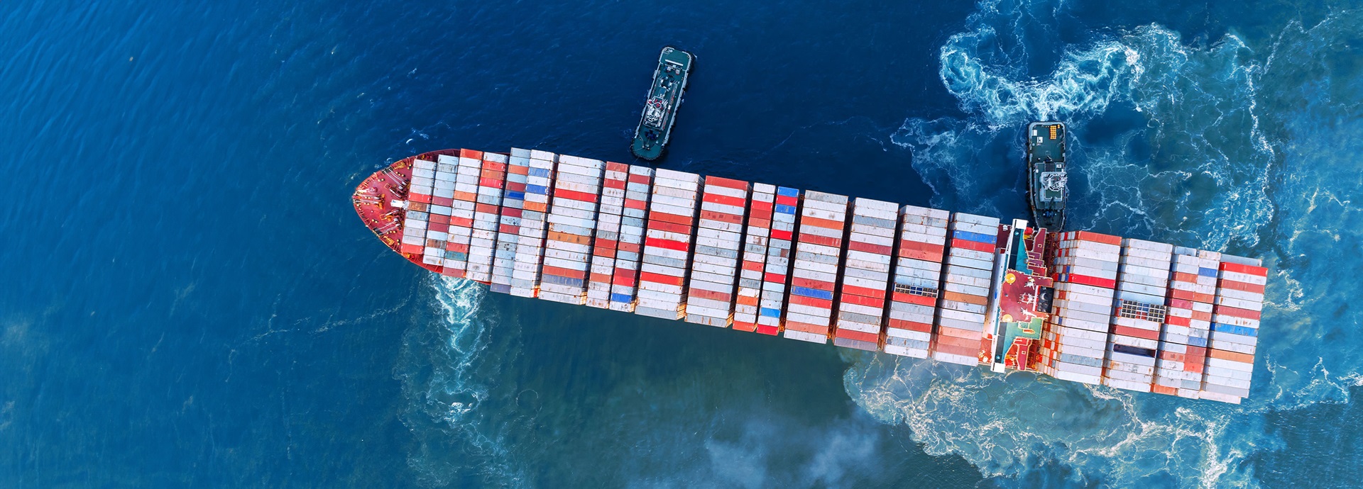 Aerial top view Tug boat drag container ship to sea port for unloading container