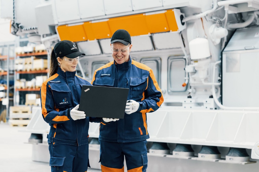 Two field engineers looking at a laptop